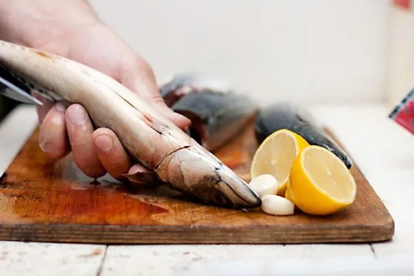 Hand cleaning fish on board